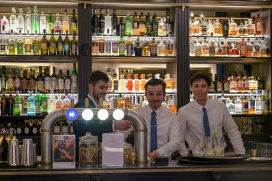 Portrait de plusieurs personnes travaillant ensemble derrière un comptoir, dans un environnement professionnel avec une ambiance conviviale